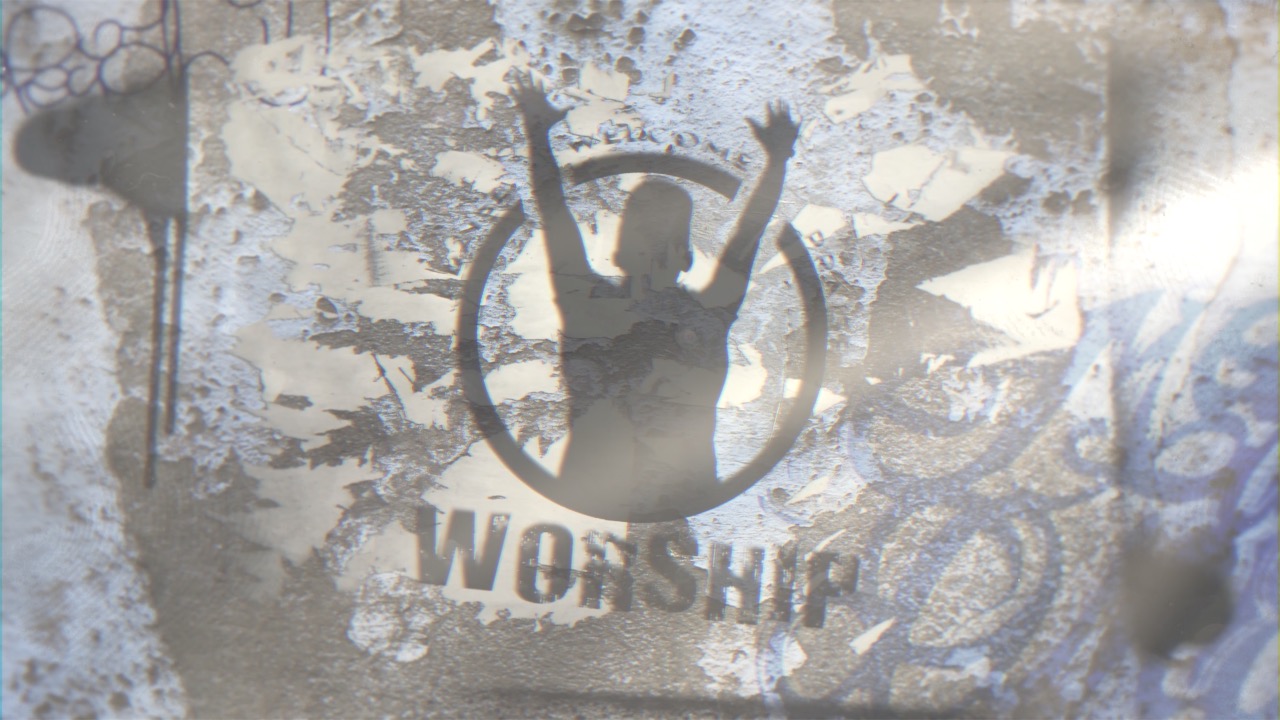 A worship stencil of a person raising their hands on a textured graffiti wall